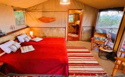 Innensicht unsere Deluxe-Zelte im Masai Mara Safari Camp mit Kingsize-Bett und Stühlen