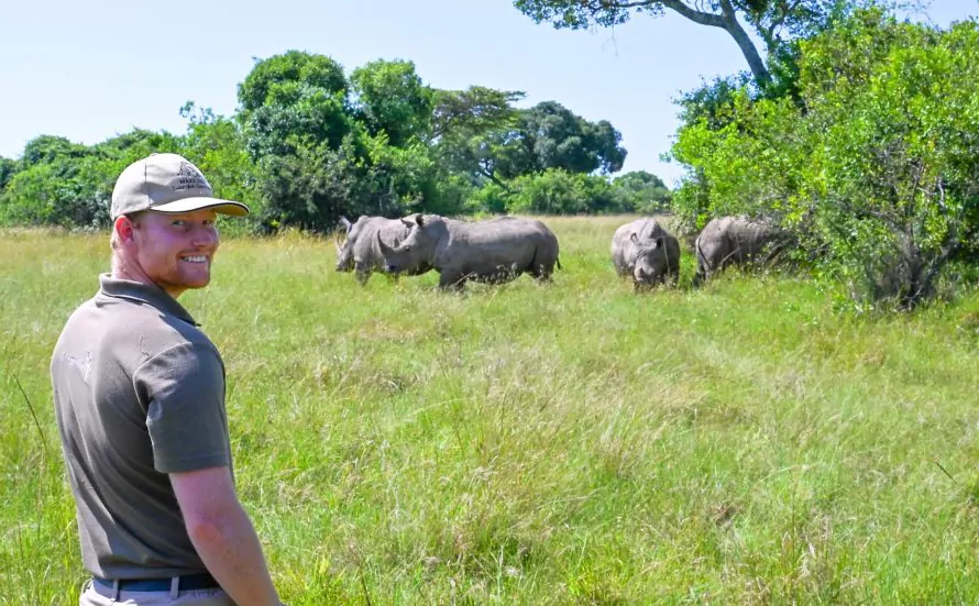 Visit Mara Elatia Sanctuary - guide in front of rhinos